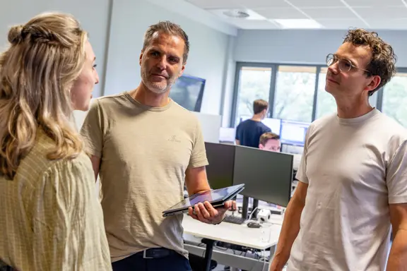 Drie medewerkers van Harbers Group in informeel overleg op de werkvloer